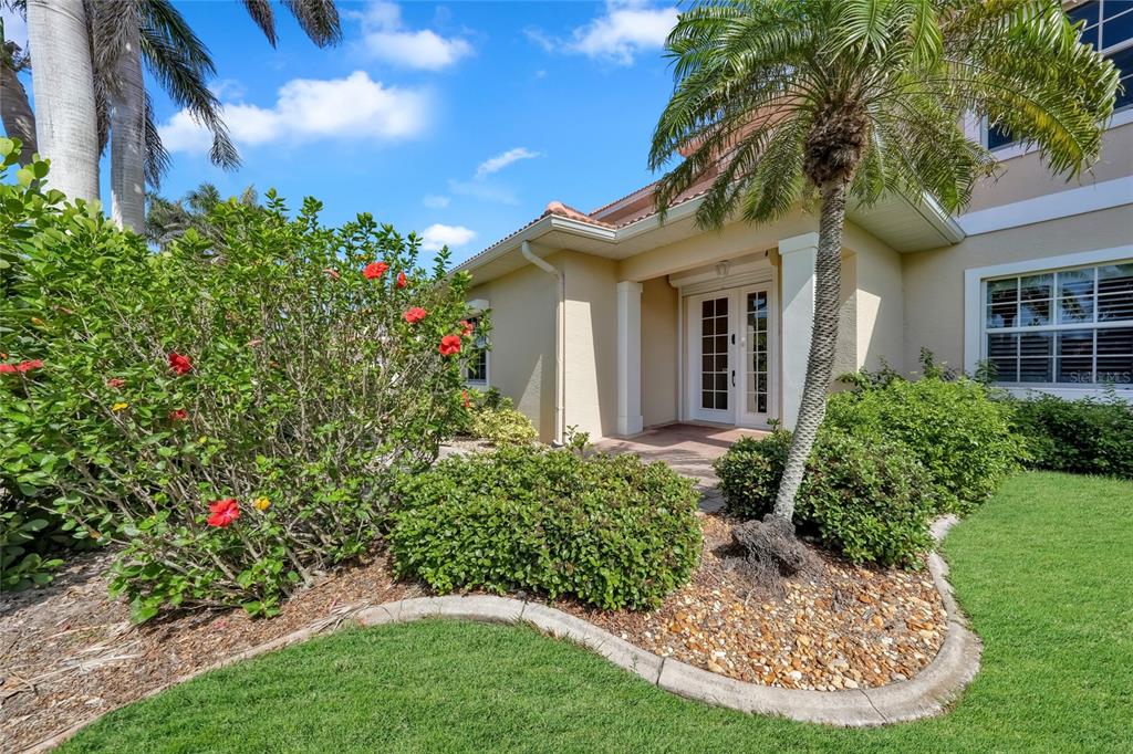 An aerial view shows a multi-unit residential building with red tile roofs and garages — 196 TARPON COVE BOULEVARD UNIT 722, PUNTA GORDA, FL