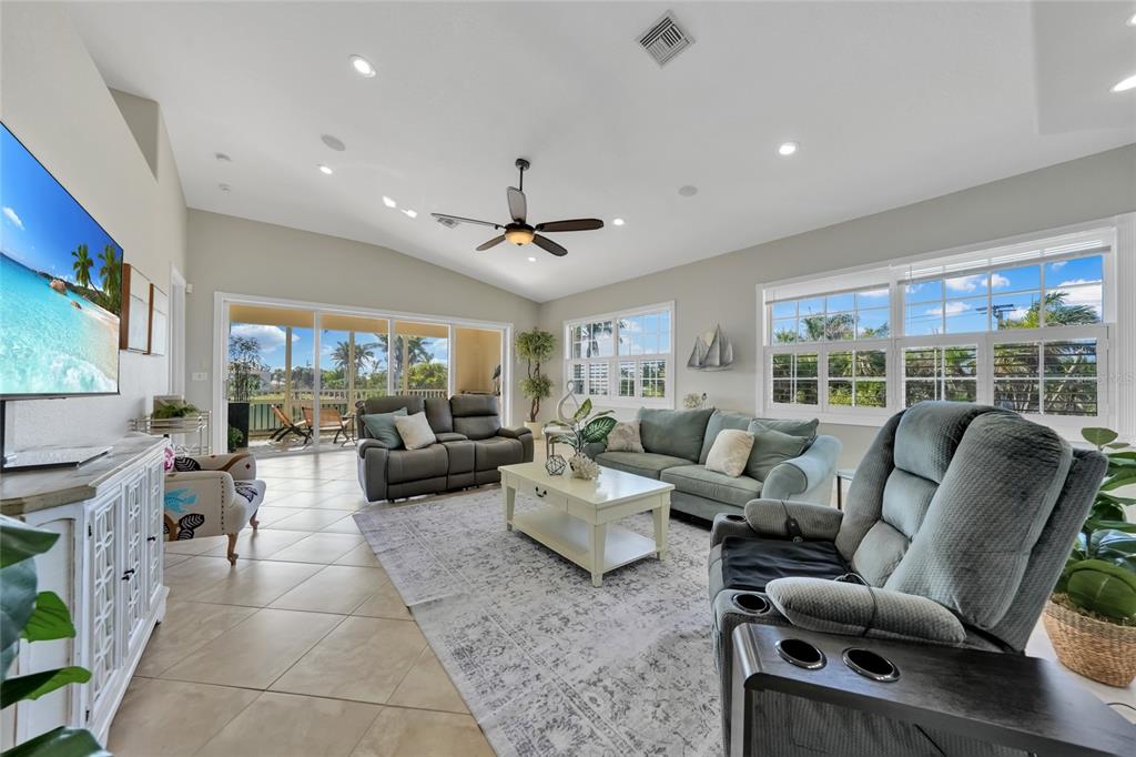 A carpeted staircase with a white wooden railing sits next to a tiled entryway — 196 TARPON COVE BOULEVARD UNIT 722, PUNTA GORDA, FL