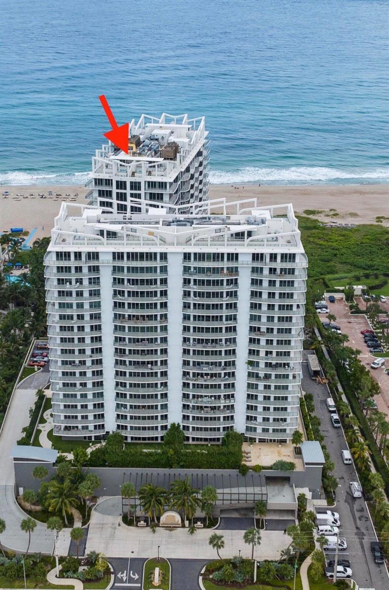 An aerial view of a white high-rise residential building located directly on the beach — 3100 N Ocean Drive # 1608, Singer Island FL 33404, SINGER ISLAND, FL