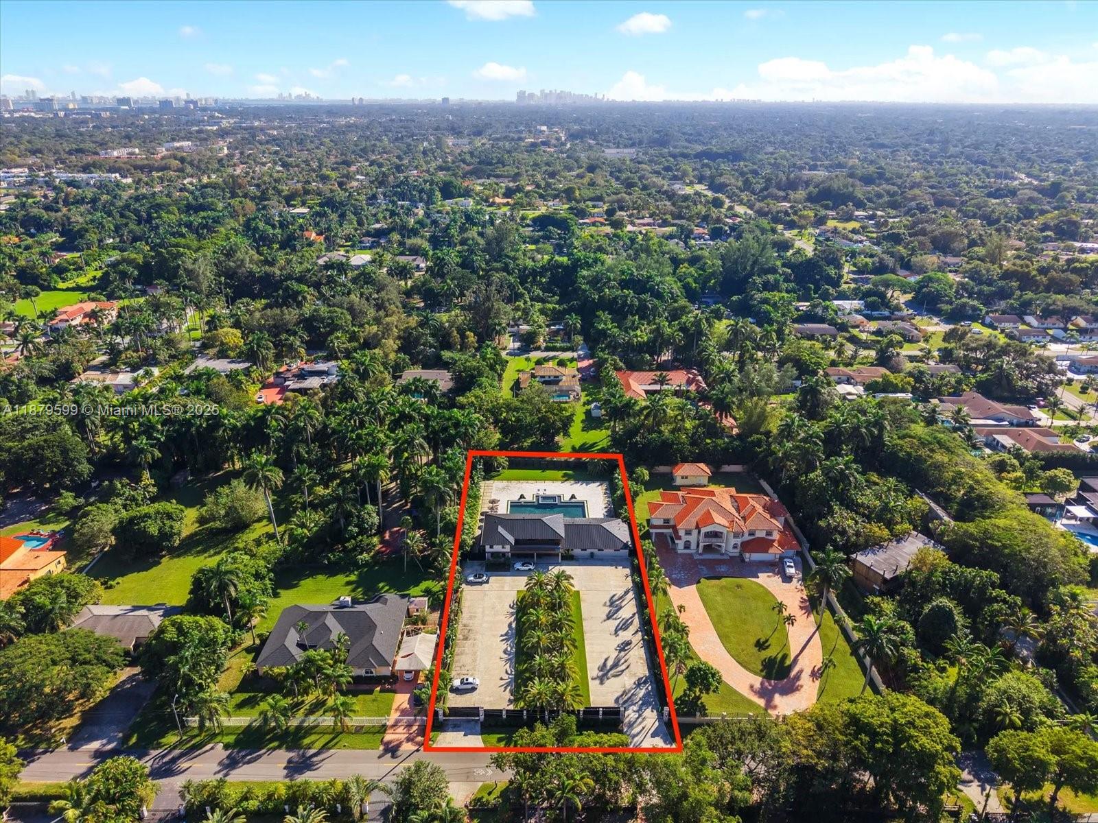 An aerial view shows a modern house with a pool and long driveway outlined in red — 280 NE 156th St, Miami FL 33162, MIAMI, FL
