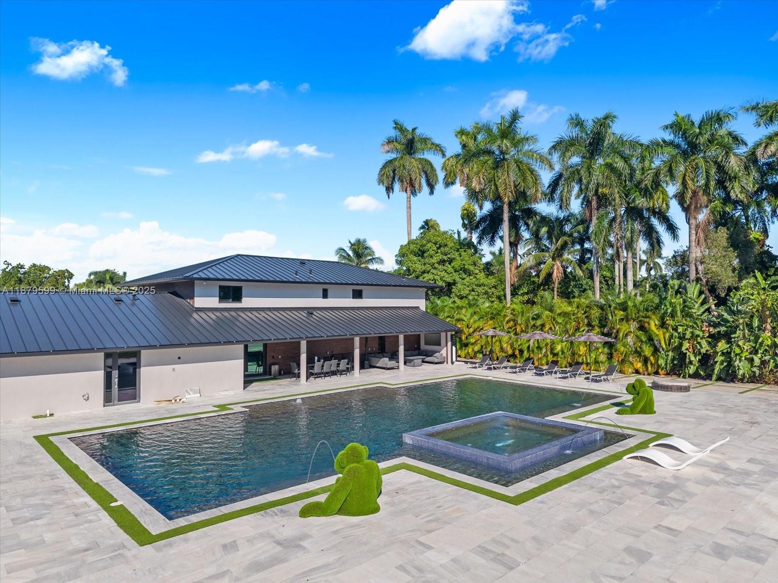 An aerial view of a modern house with a large swimming pool and topiary figures — 280 NE 156th St, Miami FL 33162, MIAMI, FL