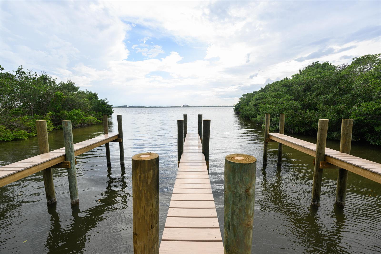A grassy lot features a line of trees and a small wooden structure — 1540 Outer Drive, Merritt Island FL 32952, MERRITT ISLAND, FL