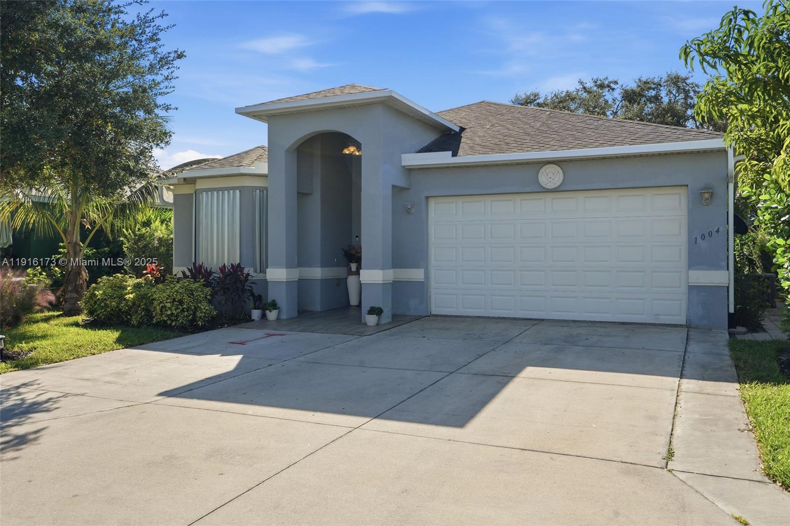 A single-story house with a blue exterior, a two-car garage, and a covered entryway — OTHER CITY - IN THE STATE OF FLORIDA, FL