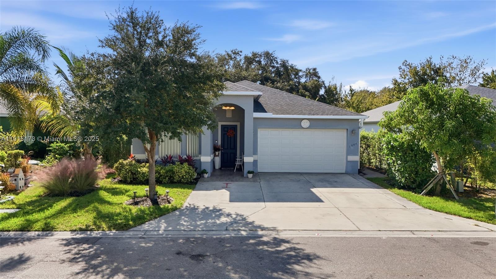 A single-story house with a gray exterior, a two-car garage, and a front driveway — OTHER CITY - IN THE STATE OF FLORIDA, FL