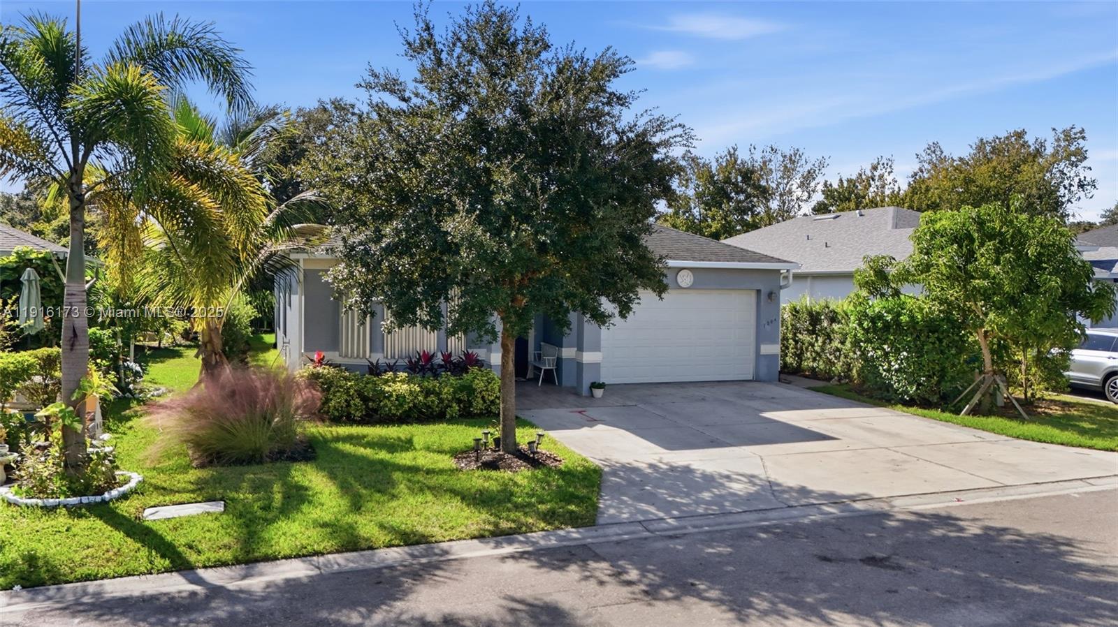 A single-story house with a white garage door, a concrete driveway, and a front lawn — OTHER CITY - IN THE STATE OF FLORIDA, FL