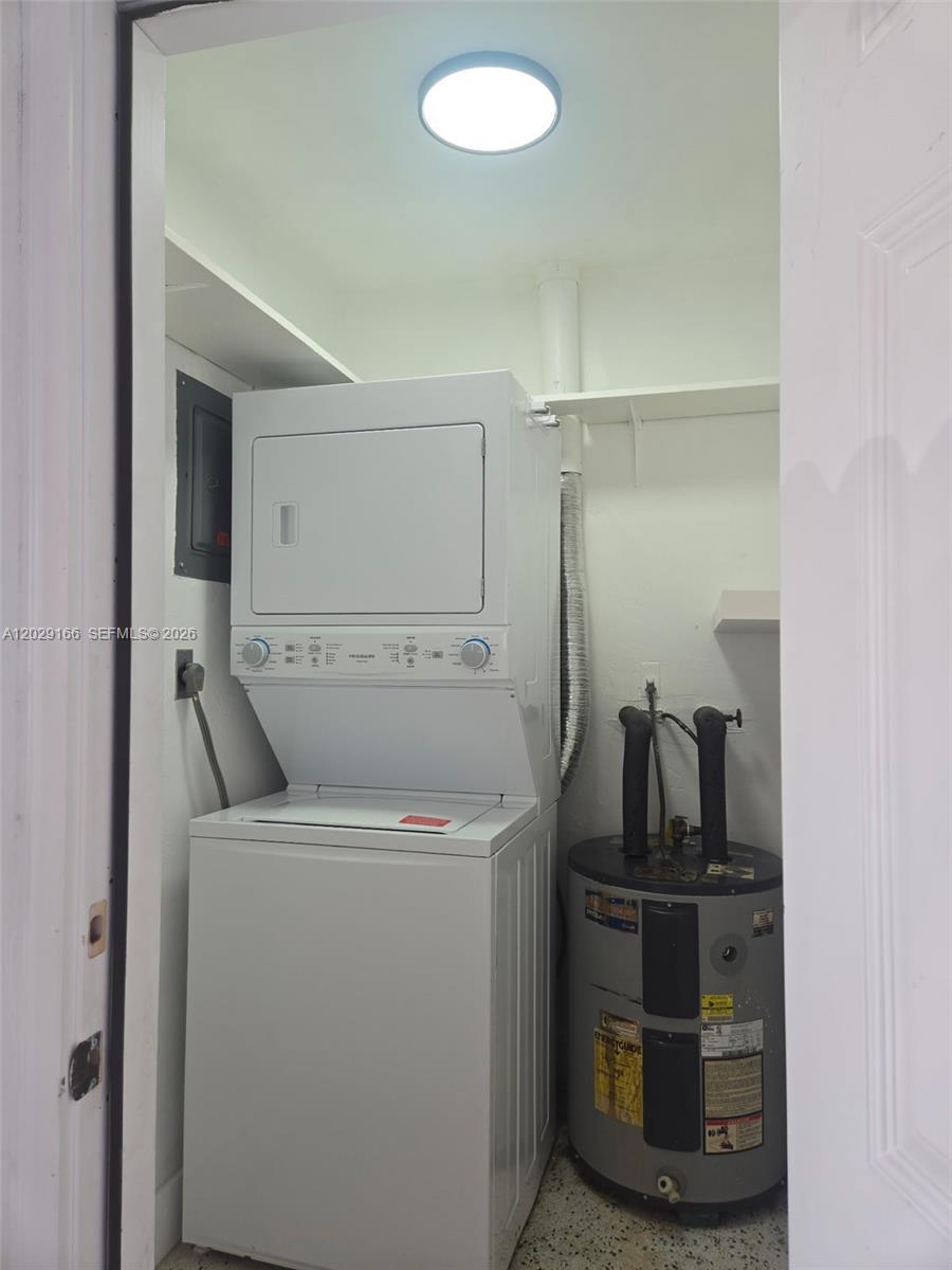 A laundry closet contains a stacked washer-dryer unit and a water heater — 3435 NW 4th St, Miami FL 33125, MIAMI, FL