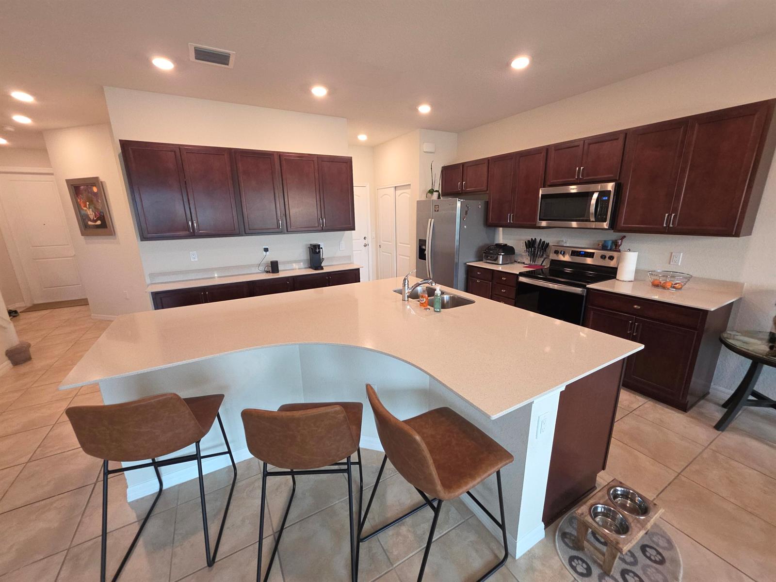 A pantry with white sliding doors and wire shelving containing various food items and supplies — 4480 W Appleton Cir W, Oakland Park FL 33309, OAKLAND PARK, FL