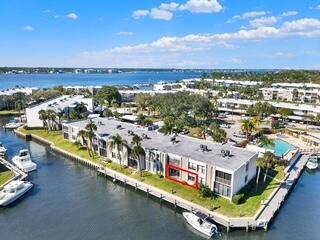 An aerial view of a waterfront apartment complex with a red box highlighting a unit — 1950 SW Palm City Road # 9102, Stuart FL 34994, STUART, FL