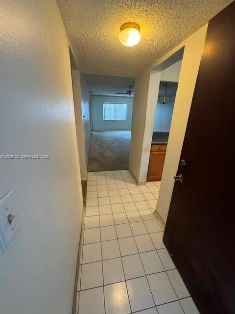 A tiled entryway leads to a carpeted living area with a window and ceiling fan — 6505 Winfield Blvd # 51, Margate FL 33063, MARGATE, FL