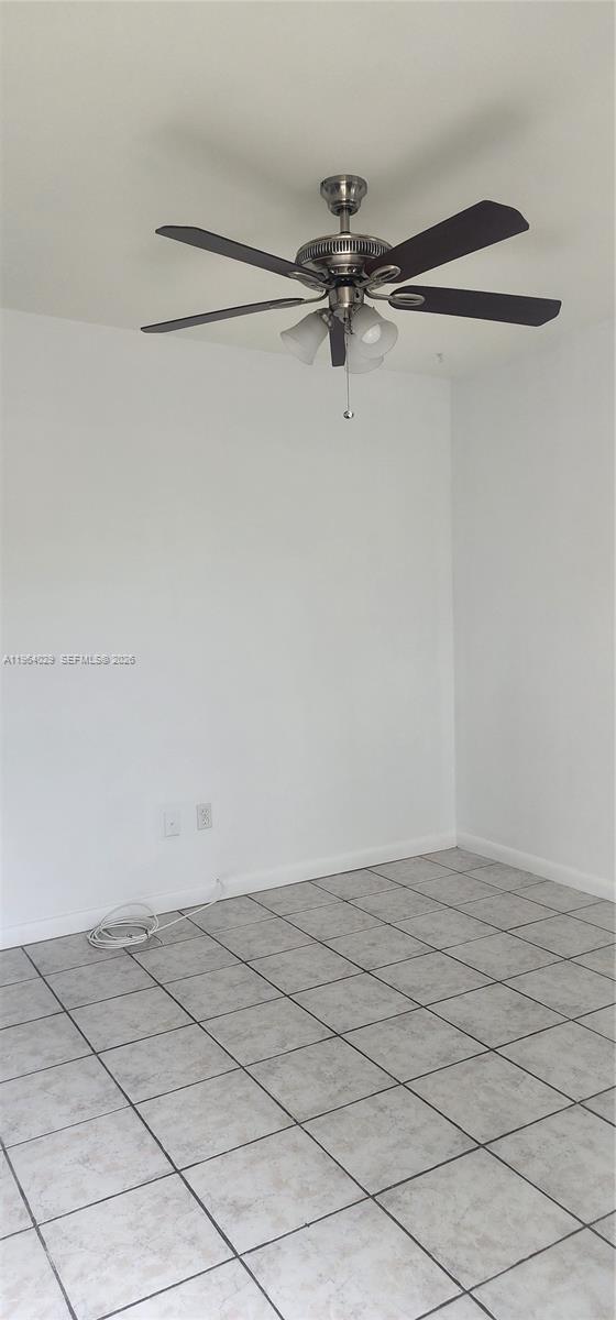 A room with white walls, a ceiling fan, and light-colored tiled flooring — 12641 SW 210th Ter # A, Miami FL 33177, MIAMI, FL
