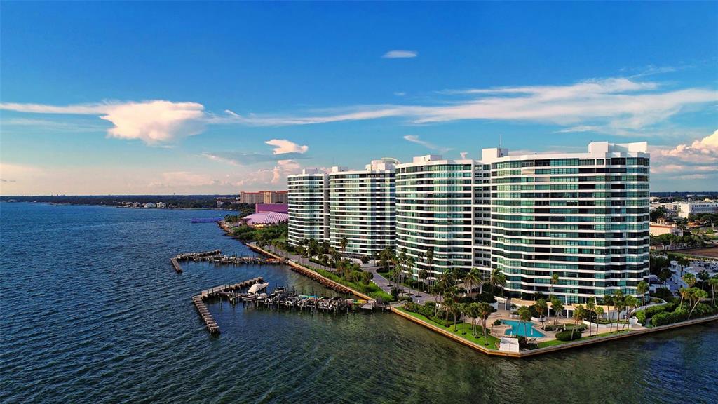 An aerial view of a large waterfront apartment complex with a private boat dock — 888 BOULEVARD OF THE ARTS UNIT 505, SARASOTA, FL