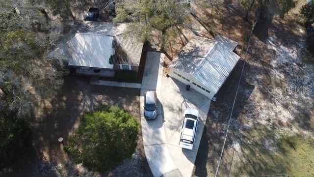 An aerial view shows a house and a detached garage connected by a concrete driveway — 1788 HIGHWAY 10A, PONCE DE LEON, FL
