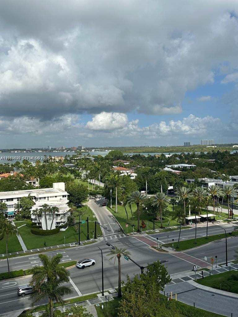 An elevated view of a street intersection surrounded by palm trees, buildings, and a bay — 10185 Collins Ave # 1103, Bal Harbour FL 33154, BAL HARBOUR, FL