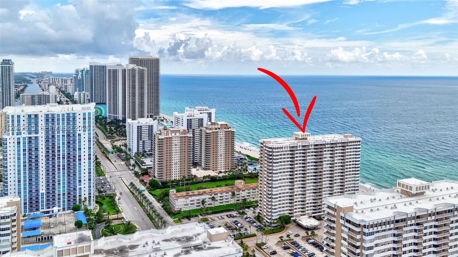 An aerial view shows high-rise residential buildings along a sandy beach and the ocean — 1950 S Ocean DR. # 6B, Hallandale Beach FL 33009, HALLANDALE BEACH, FL