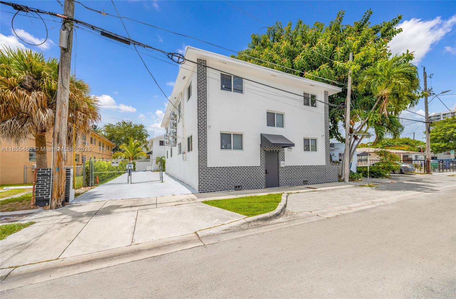 A two-story white building with gray brick accents stands on a corner lot — 1028 SW 9th Ave, Miami FL 33130, MIAMI, FL