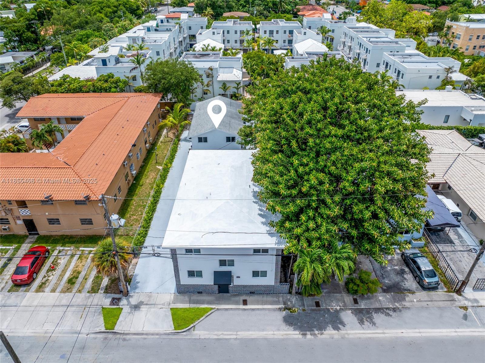 An aerial view shows a white multi-story building with a large tree and parking — 1028 SW 9th Ave, Miami FL 33130, MIAMI, FL