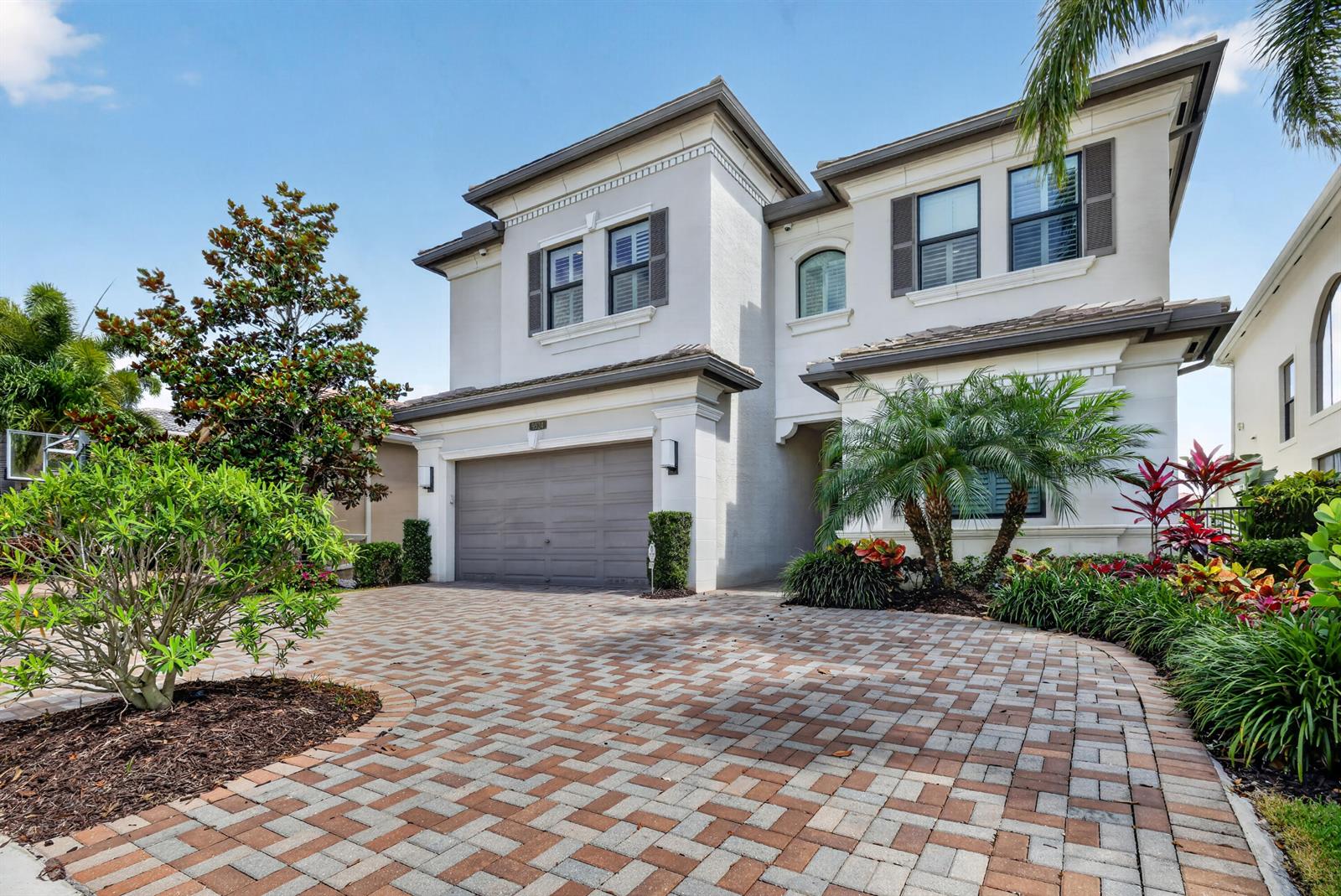 A two-story house with a paved driveway, a two-car garage, and landscaped front yard — 9524 Eden Roc Court, Delray Beach FL 33446, DELRAY BEACH, FL