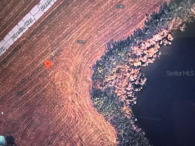 This is an aerial map view of a vacant lot bordering a body of water — 12571 GREENLING WAY, PLACIDA, FL