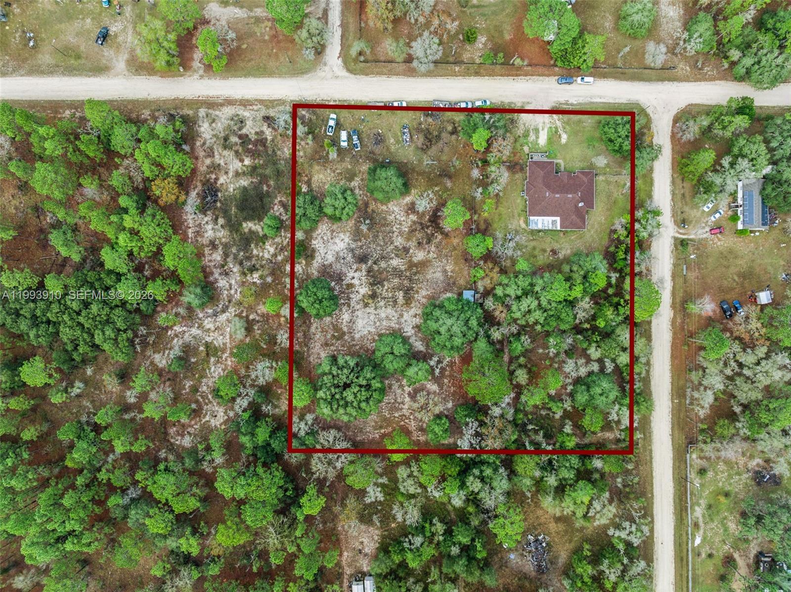 This aerial view shows a house situated on a large, partially wooded lot — 14170 SE 4th St., Williston FL 32696, WILLISTON, FL