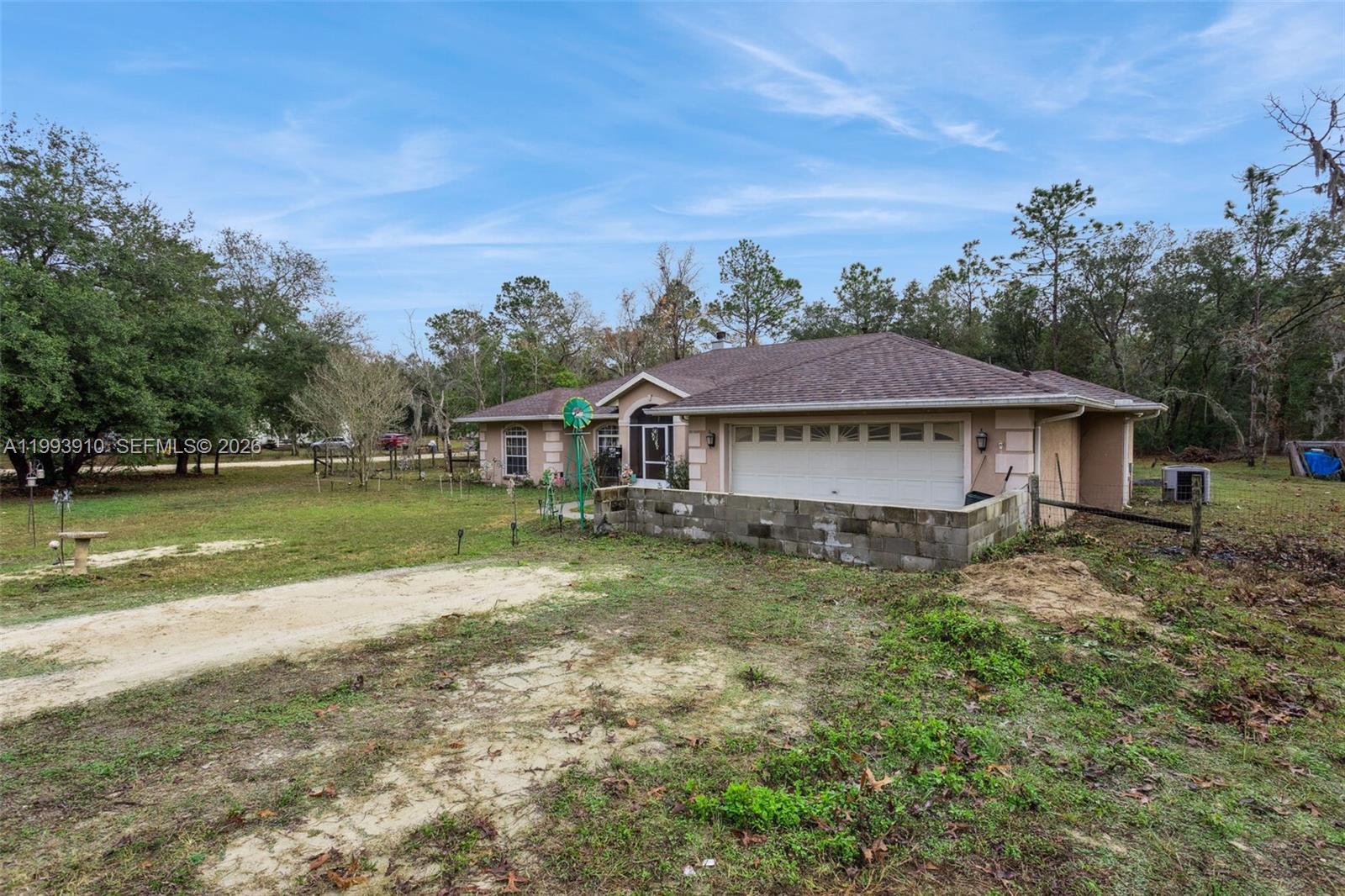 A single-story house with a two-car garage and a low concrete block wall exterior — 14170 SE 4th St., Williston FL 32696, WILLISTON, FL