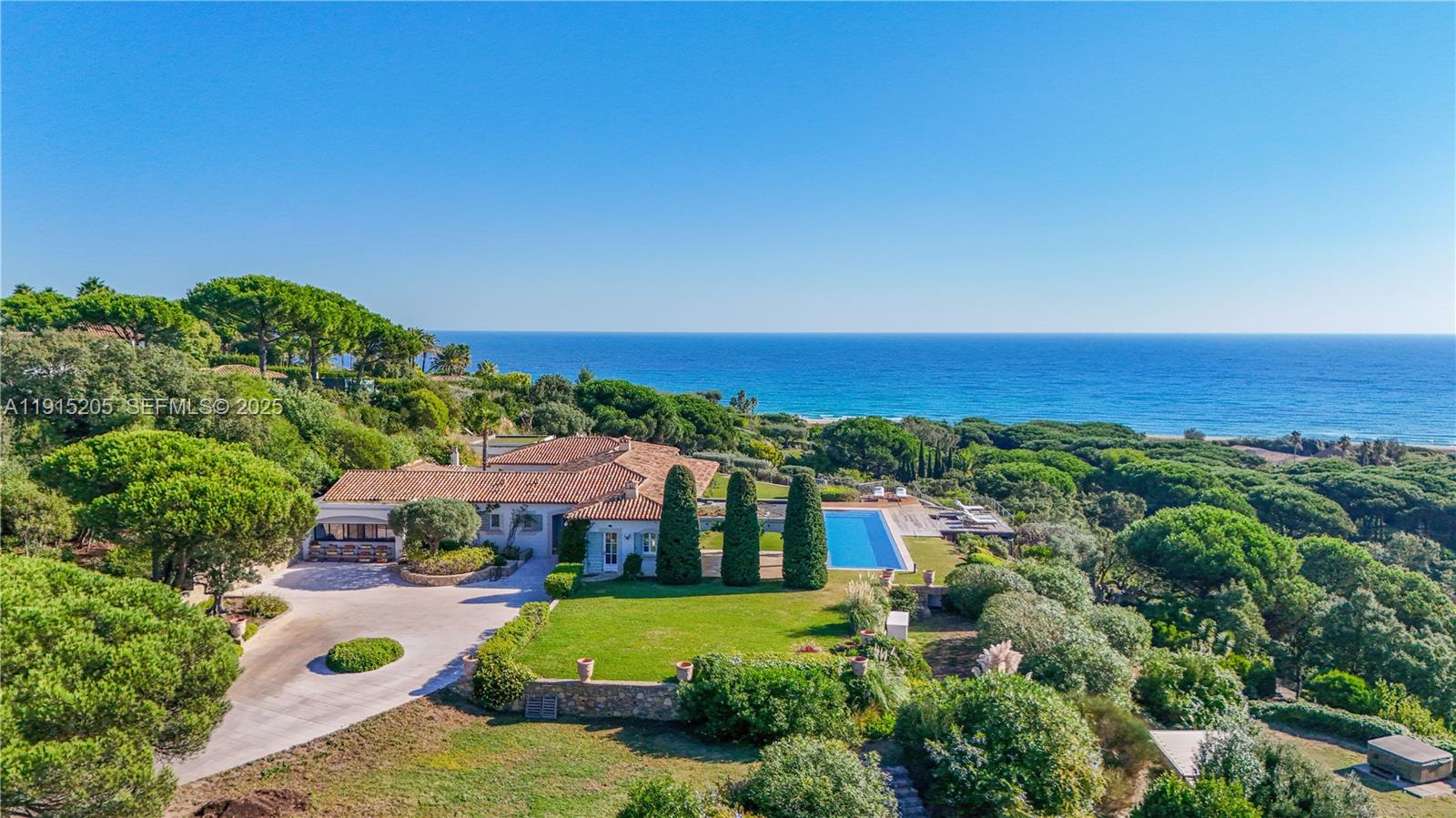 An aerial view shows a Mediterranean-style villa with a pool overlooking the ocean — Allee Des Palmiers La belle, ID 83330, ID