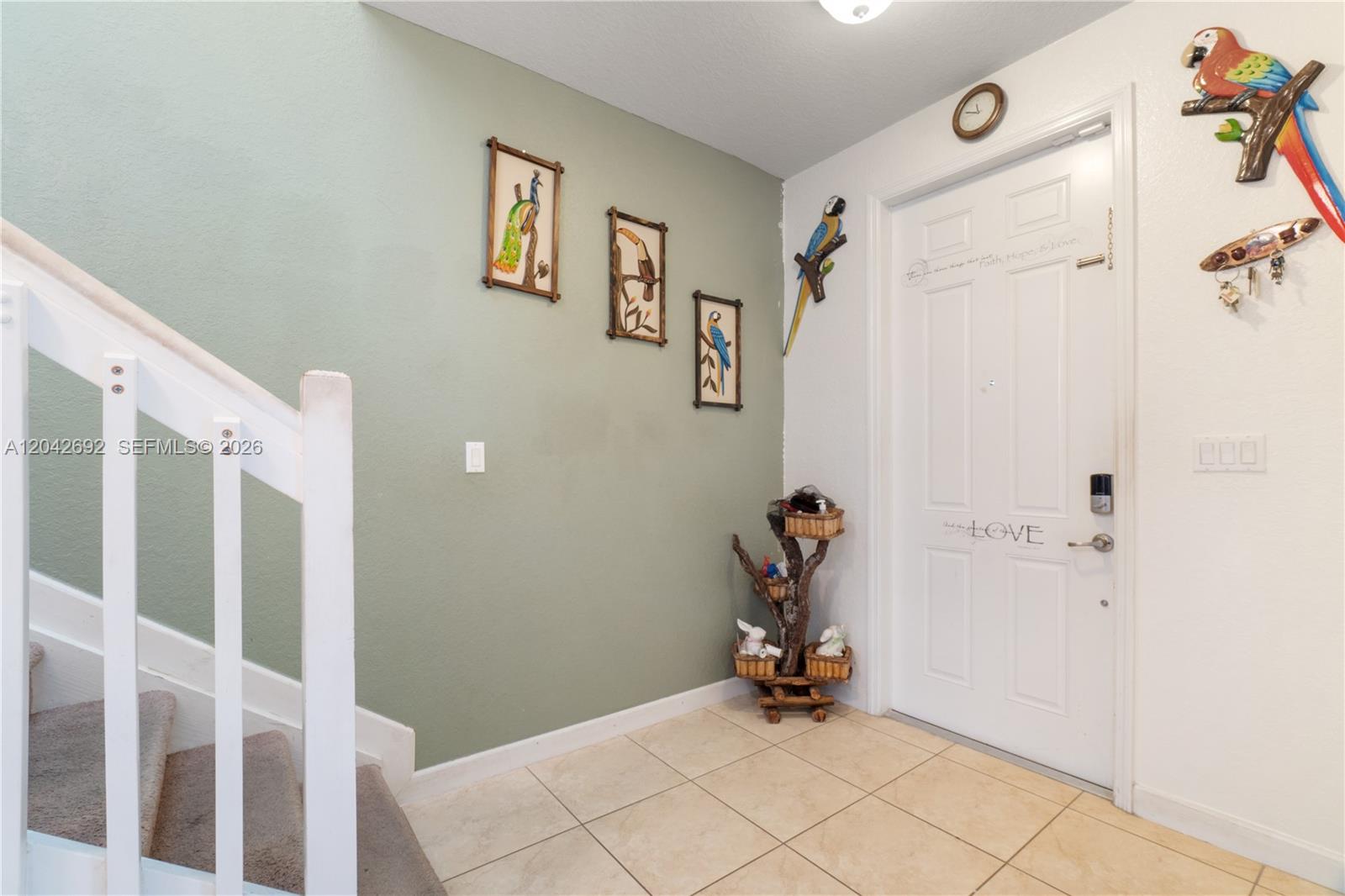 An entryway features a green accent wall, a white front door, and a staircase — 3379 NE 1st St, Homestead FL 33033, HOMESTEAD, FL