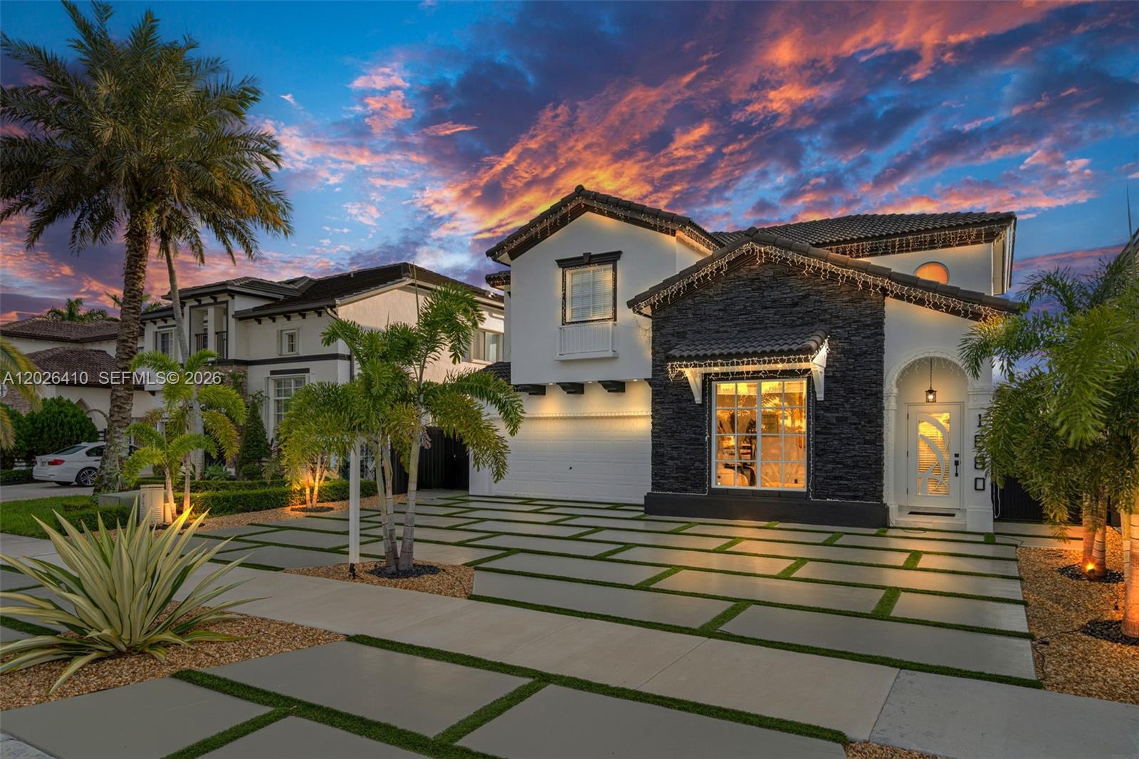 A two-story house with a stone facade, white walls, and a modern paver driveway — 1680 SW 154th Path, Miami FL 33185, MIAMI, FL
