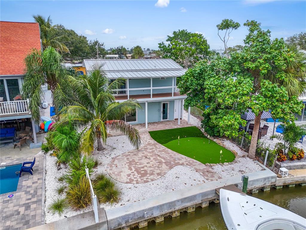 An aerial view of a waterfront house with a putting green and a boat dock — 349 BAHIA VISTA DRIVE, INDIAN ROCKS BEACH, FL