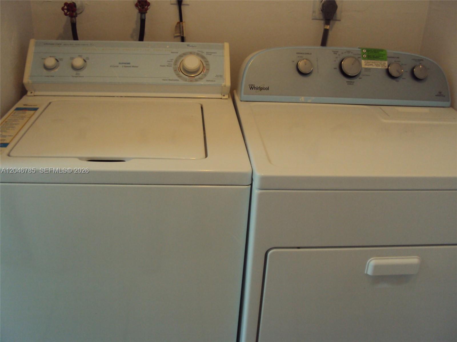 A white top-loading washing machine and a matching dryer sit side-by-side against a wall — 8401 SW 107th Ave # 247E, Miami FL 33173, MIAMI, FL