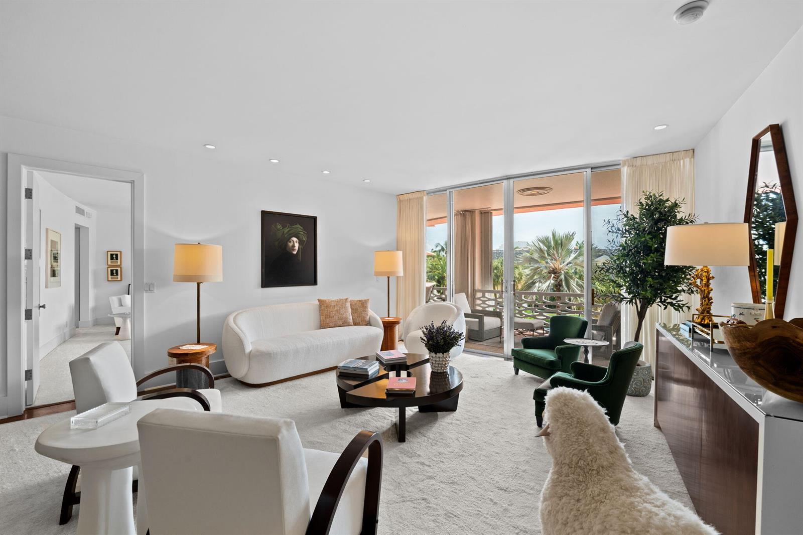 A bright living room features white furniture, green accent chairs, a coffee table, and balcony access — 315 S Lake Drive # 3d, Palm Beach FL 33480, PALM BEACH, FL