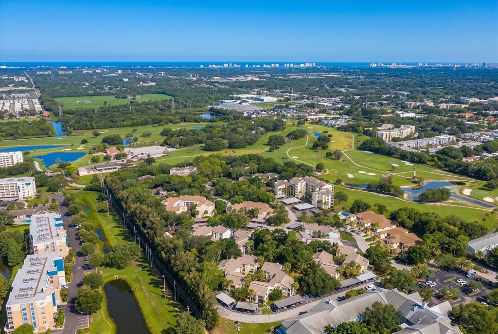 An aerial view shows a residential complex surrounded by a golf course and green space — 700 STARKEY ROAD UNIT 624, LARGO, FL