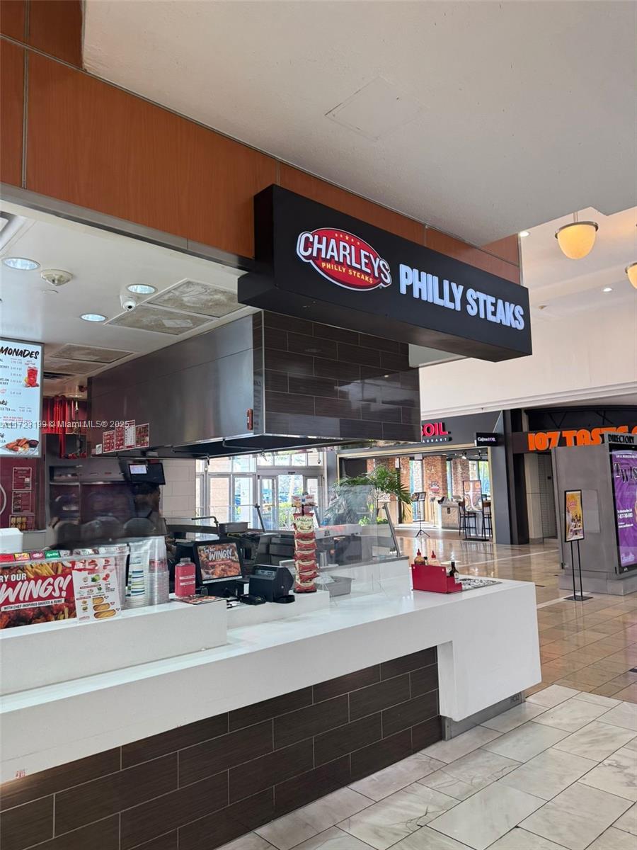 A Charleys Philly Steaks restaurant counter is located inside a shopping mall food court — 8000 W BROWARD BLVD, Plantation FL 33388, PLANTATION, FL