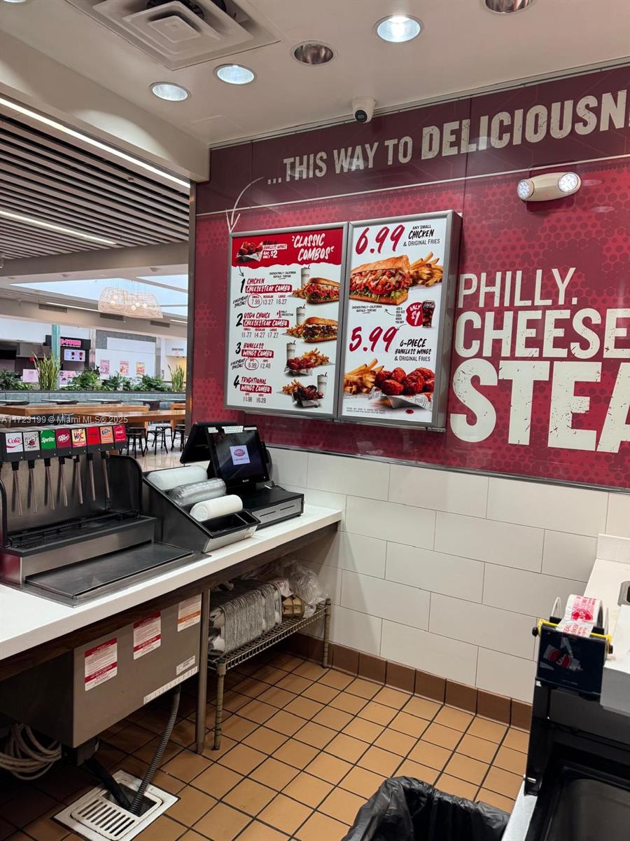 A fast-food restaurant counter features a menu board, soda fountain, and tiled flooring — 8000 W BROWARD BLVD, Plantation FL 33388, PLANTATION, FL