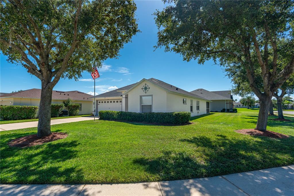 A single-story house with a light-colored exterior, a garage, and a large front lawn — 6816 AMICI COURT, PORT ORANGE, FL