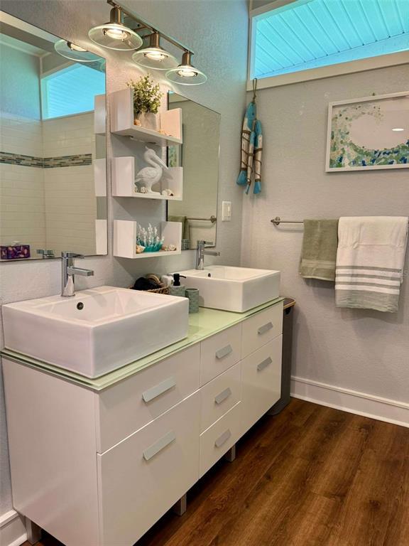 A modern bathroom features a double vanity with vessel sinks and white cabinetry — 3012 GRAND VIEW AVENUE, CLEARWATER, FL