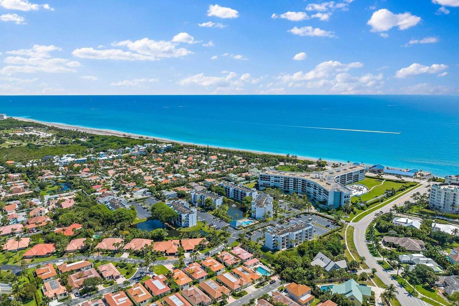 An aerial view shows a coastal residential neighborhood with apartment buildings near the ocean — 1605 S Us Highway 1 # C103, Jupiter FL 33477, JUPITER, FL
