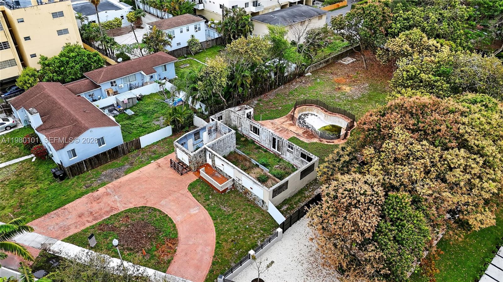 An aerial view shows a partially demolished house with an adjacent pool and large yard — 12395 Griffing Blvd, North Miami FL 33161, NORTH MIAMI, FL