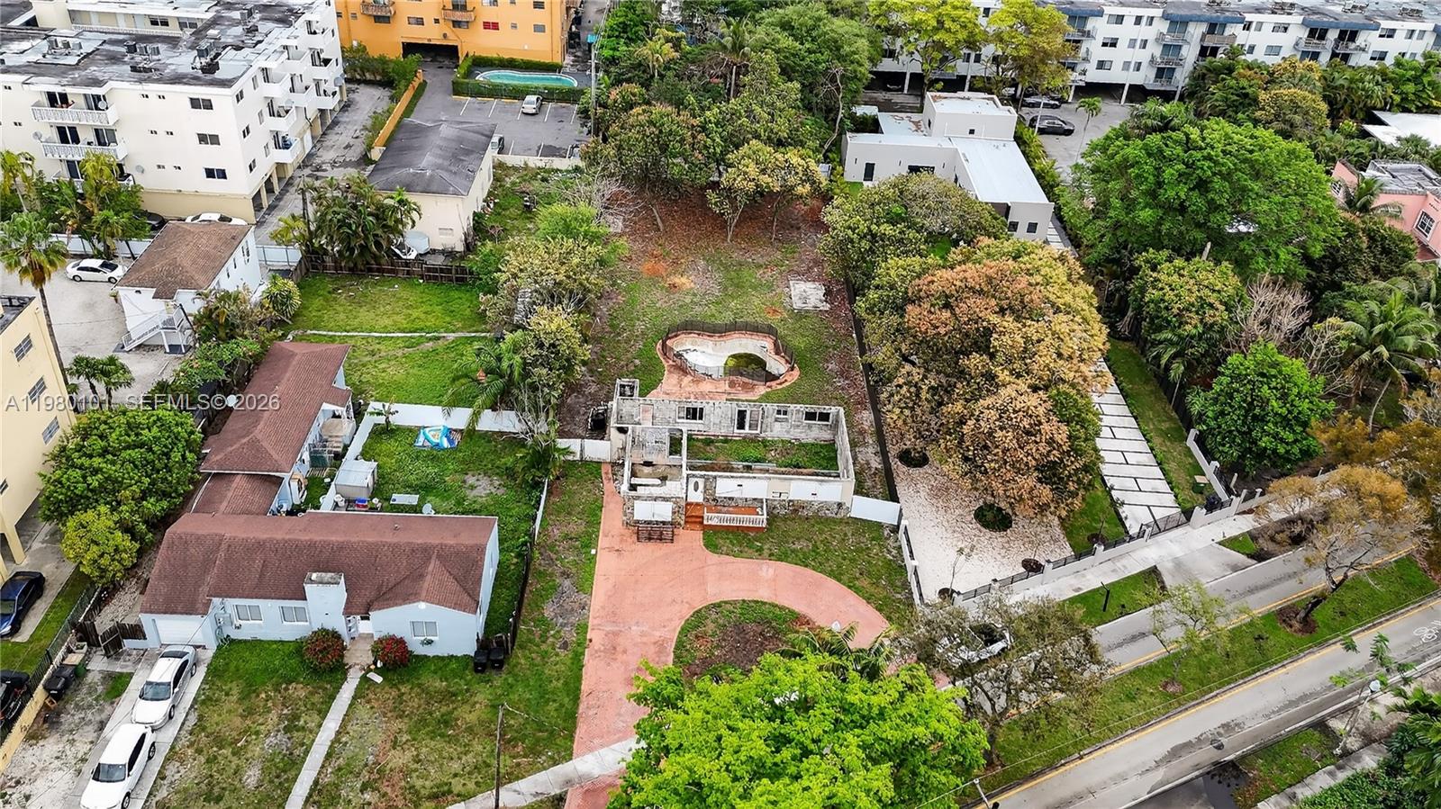 An aerial view shows a residential lot with a dilapidated house, pool, and driveway — 12395 Griffing Blvd, North Miami FL 33161, NORTH MIAMI, FL