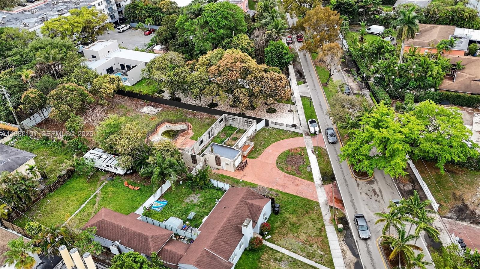 An aerial view shows a residential lot with a partially demolished structure and a pool — 12395 Griffing Blvd, North Miami FL 33161, NORTH MIAMI, FL