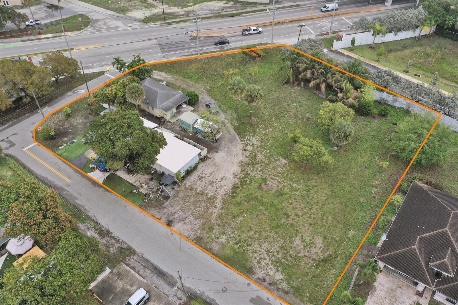 An aerial view shows a corner lot with a house and a large grassy yard — 0 NW 7th Street, Pompano Beach FL 33060, POMPANO BEACH, FL