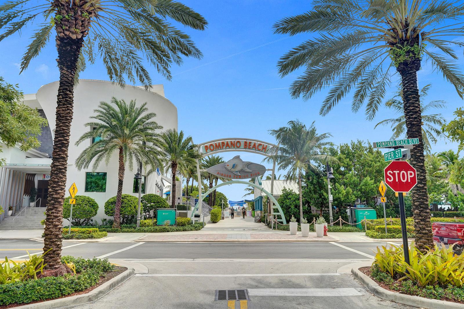A street view of the Pompano Beach entrance archway with palm trees and a stop sign — 0 NW 7th Street, Pompano Beach FL 33060, POMPANO BEACH, FL