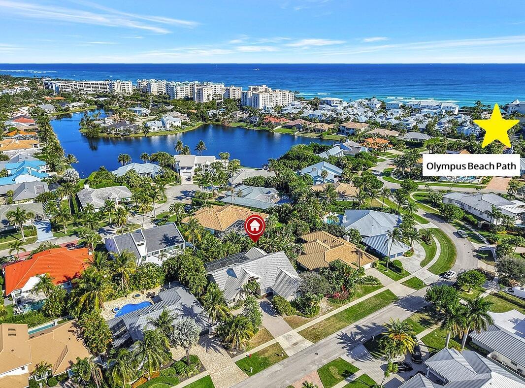 Aerial view of a residential neighborhood with a lake, beach access, and single-family homes — 115 Olympus Way, Jupiter FL 33477, JUPITER, FL
