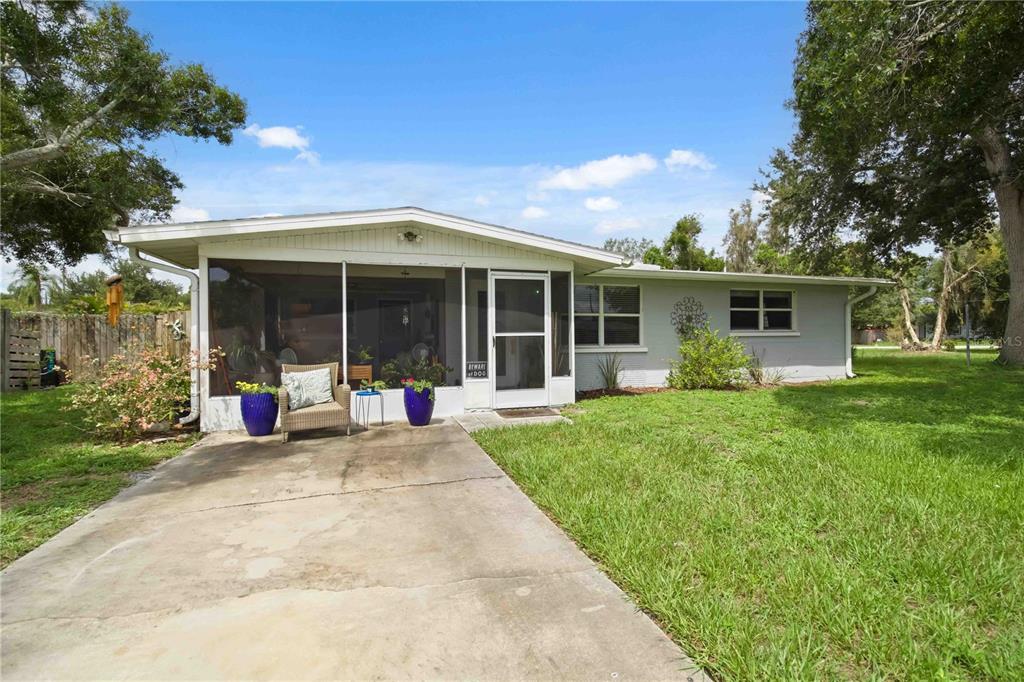 A single-story house with a screened-in front porch and a concrete driveway — 535 CARUSO PLACE, SARASOTA, FL