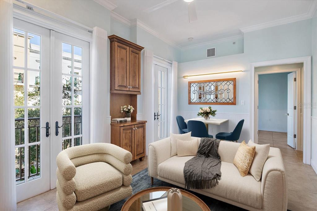 A living room features a cream sofa, a textured armchair, and a small dining area — 445 N ORANGE AVENUE UNIT 210, SARASOTA, FL