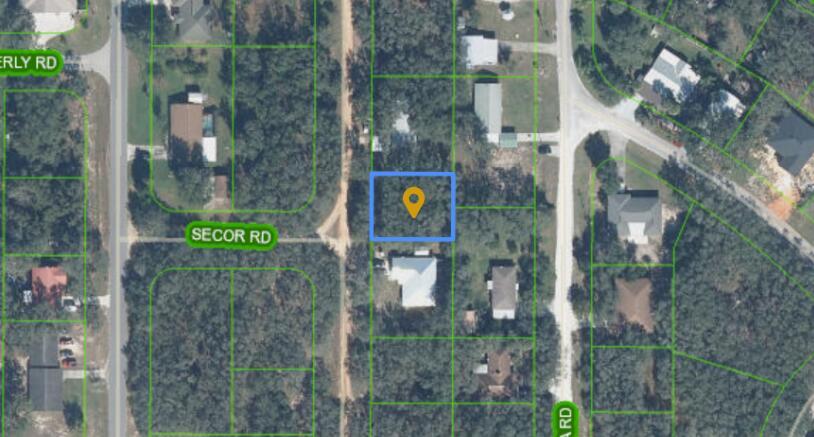 This is an aerial map view showing a highlighted rectangular plot of land with trees — 1864 N Fantasy Road, FL 33825, FL