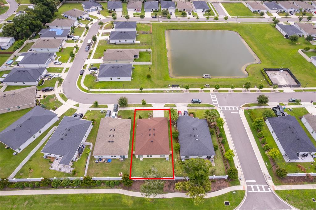 An aerial view shows a single-family home with a brown roof outlined in red — 2405 BULRUSH DRIVE, ST CLOUD, FL