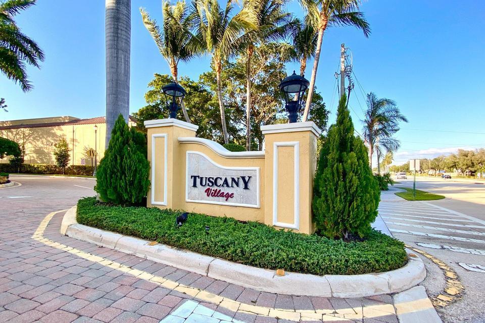 A tan monument sign for Tuscany Village stands in a landscaped traffic island — 210 NE 69th Circle, Boca Raton FL 33487, BOCA RATON, FL