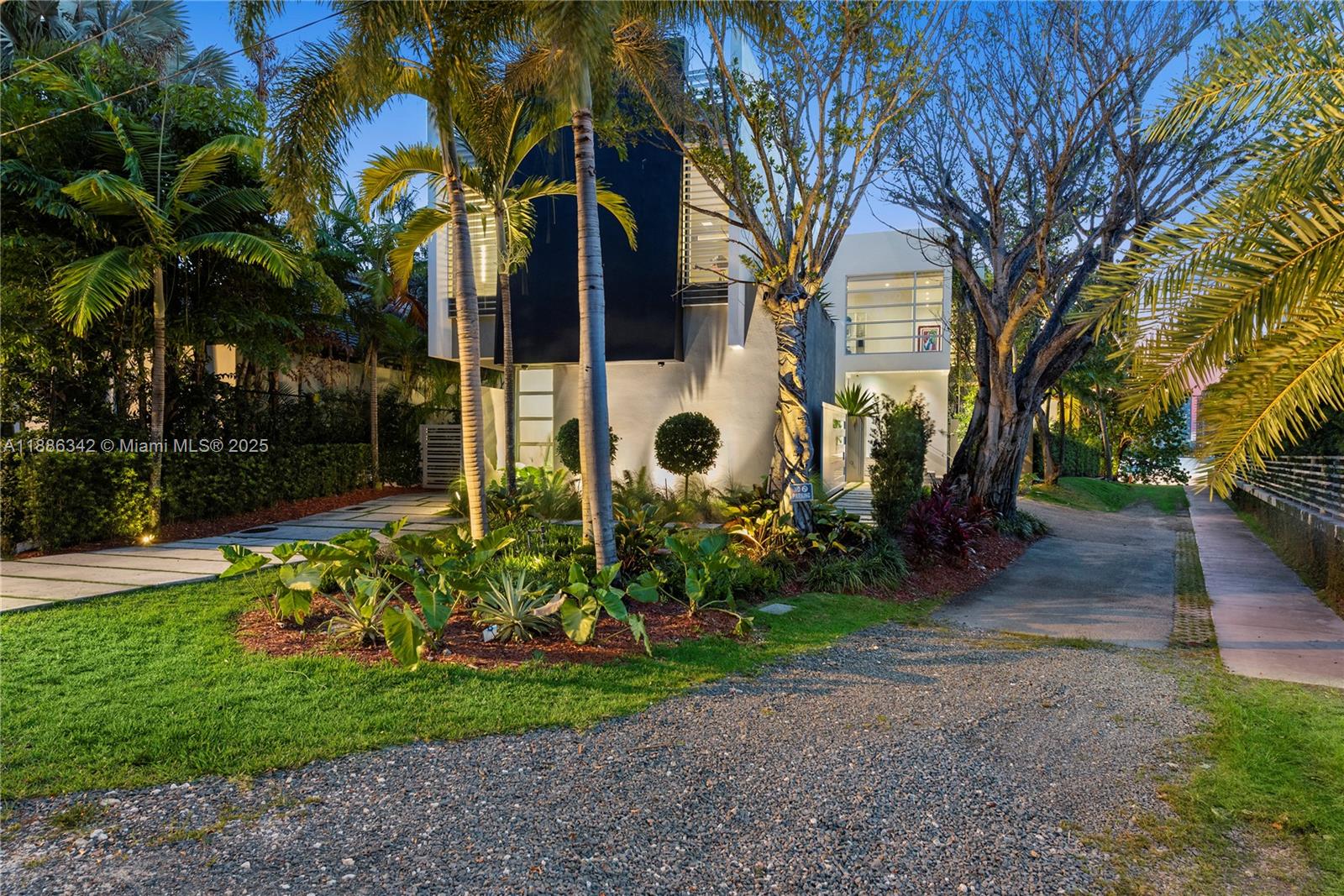 A modern two-story house with a black facade is surrounded by palm trees and landscaping — 440 S Hibiscus Dr, Miami Beach FL 33139, MIAMI BEACH, FL