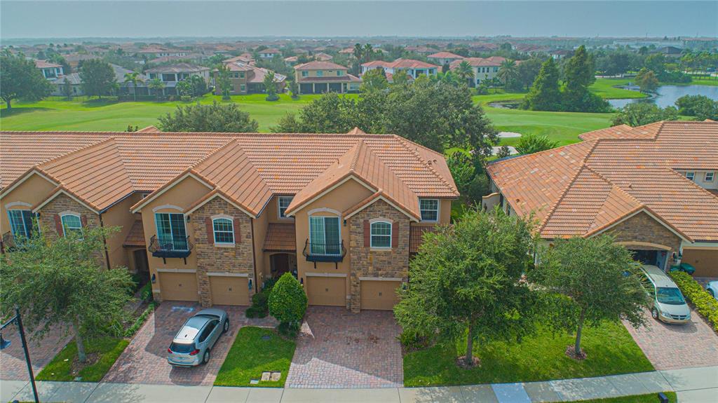 An aerial view of a multi-unit residential building with tile roofs and brick driveways — 10665 BELFRY CIRCLE, ORLANDO, FL