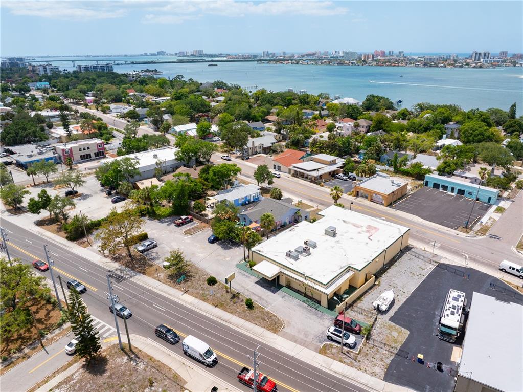 An aerial view shows a commercial building with a flat roof near a coastal waterway — 1610 N MYRTLE AVENUE, CLEARWATER, FL